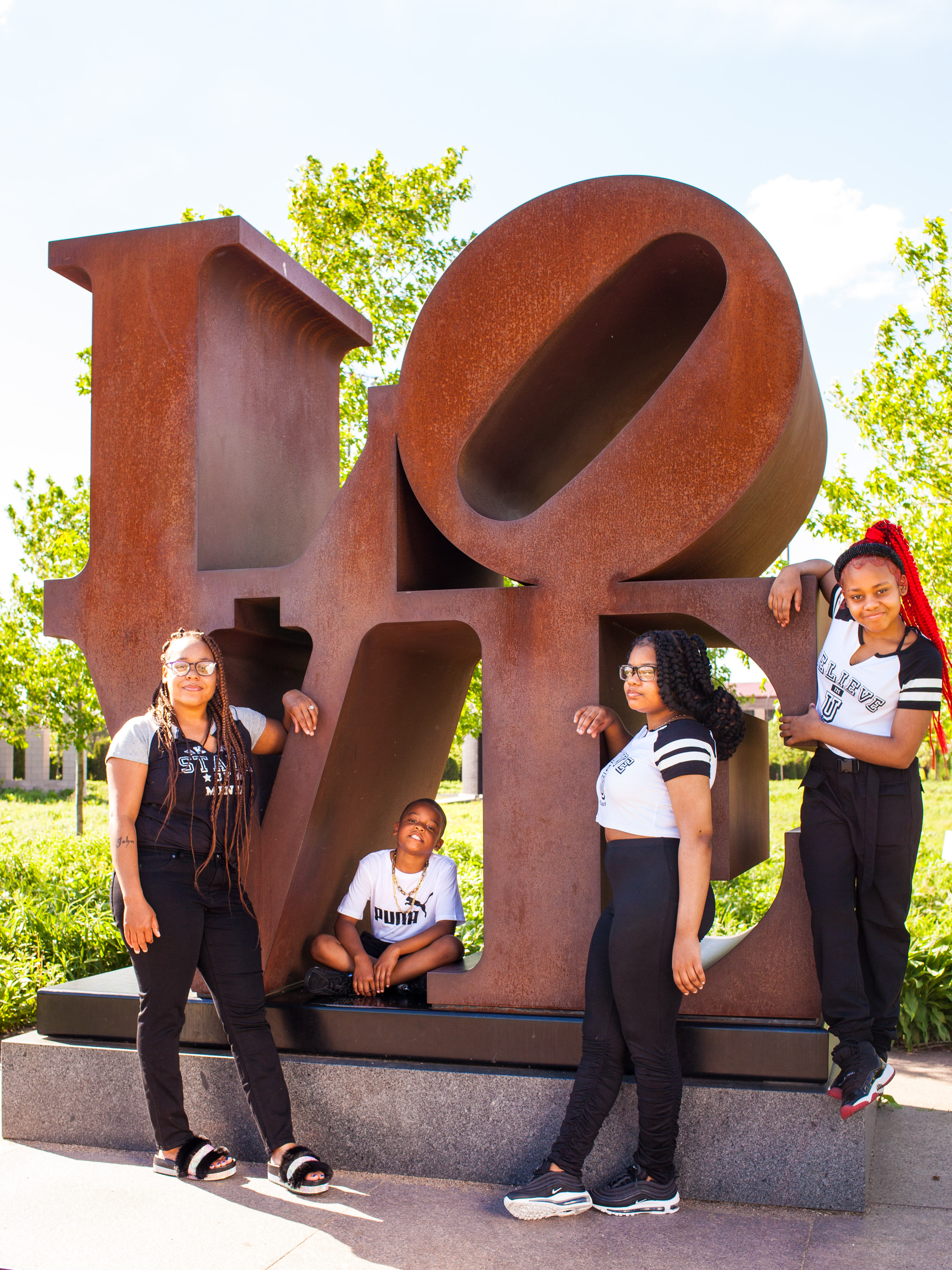 Rahiyma and her family stand at the LOVE sculpture.