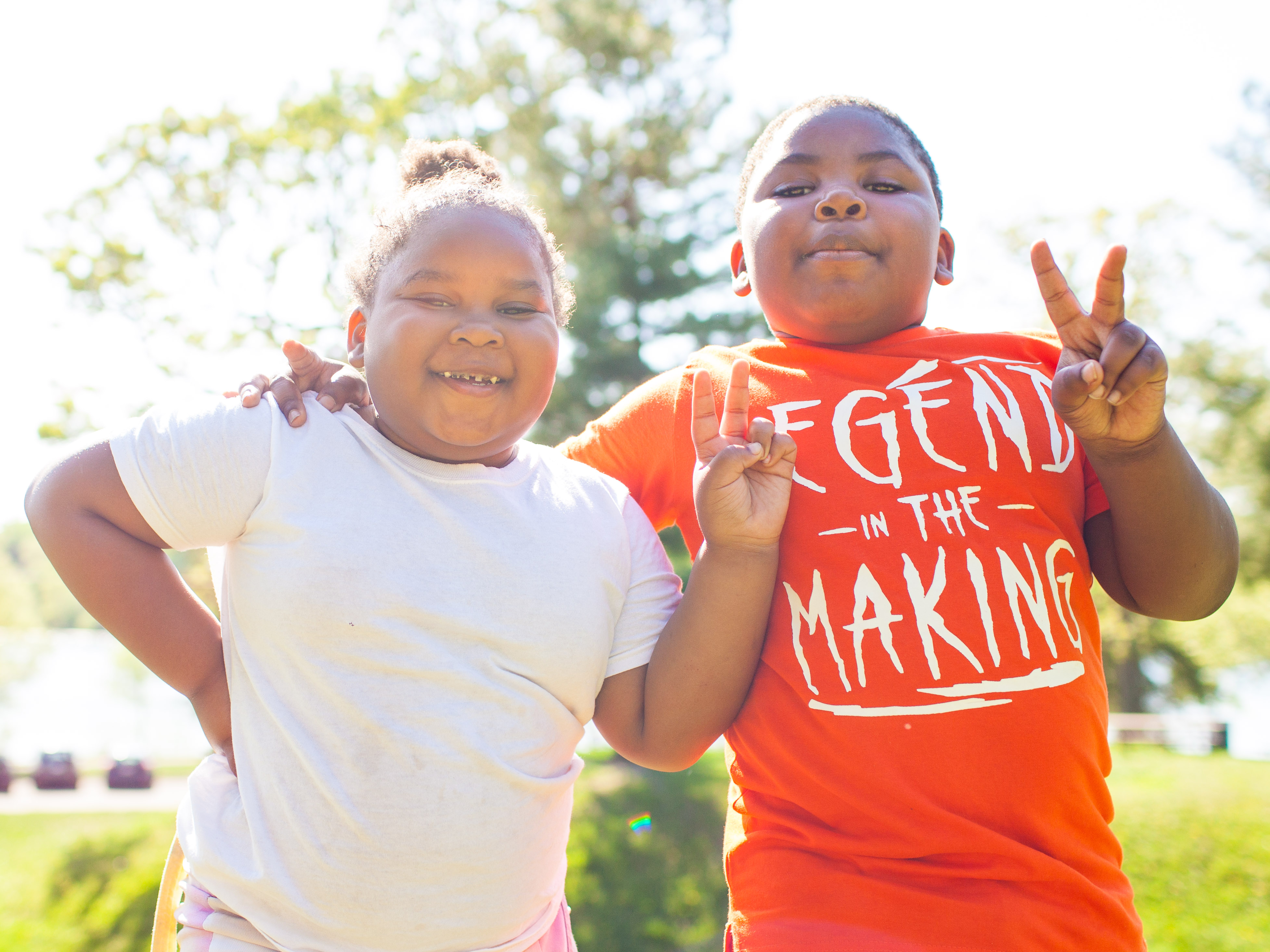 two scholars putting up peace signs. 