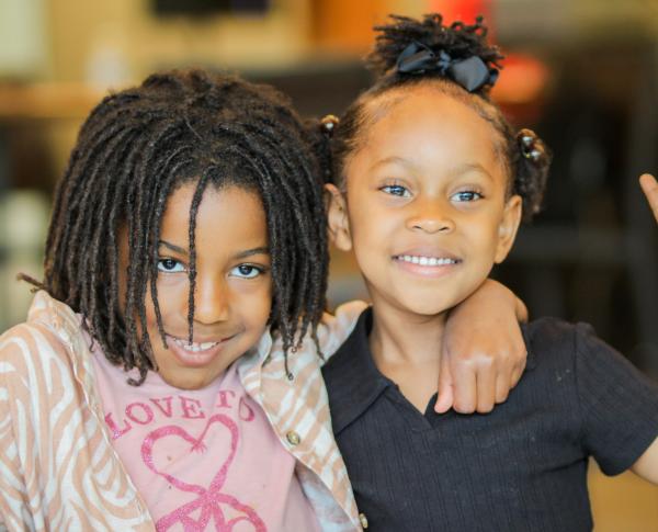 Two children smile together