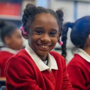 Young girl smiles at camera