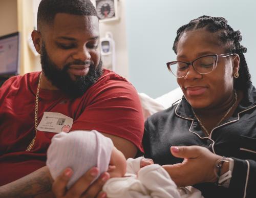 Man and woman holding their baby