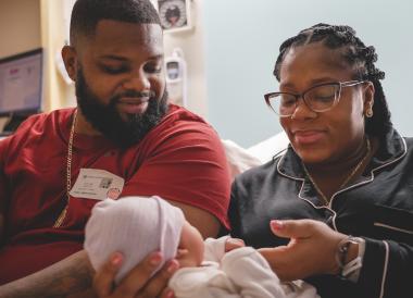Man and woman holding their baby