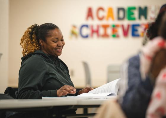 A young Black woman is in a class, learning about career opportunities.