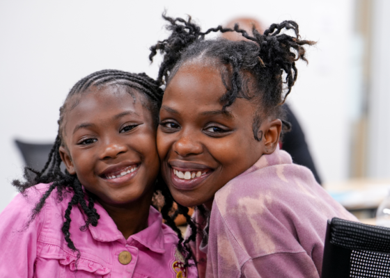 Mother and daughter smiling at the camera