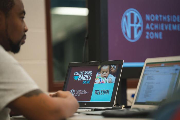 _ A computer screen showing a presentation in front of a man.