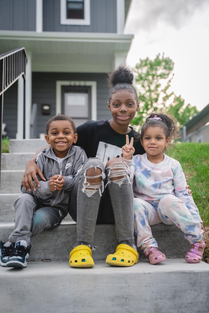 Siblings on their front step