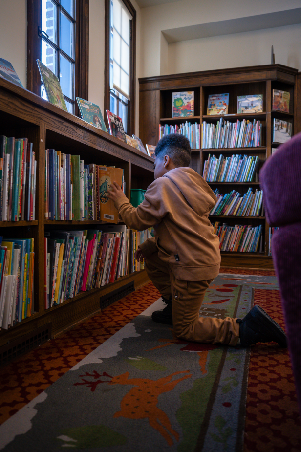 Shai by the bookshelf