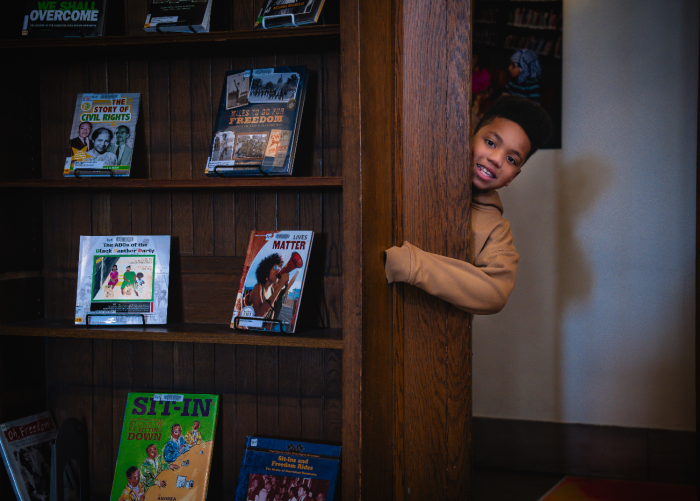 Shai in the book nook Shai peeking his head around a corner of the book nook