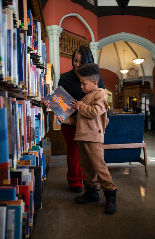 Shai and Rasheena looking at a book together Shai and Rasheena looking at a book together