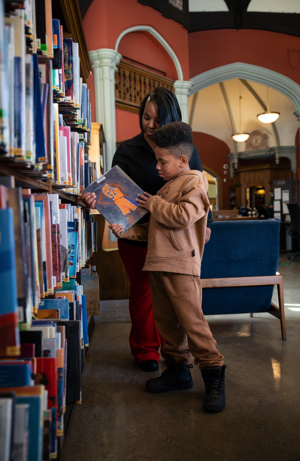 Shai and Rasheena looking at a book together 