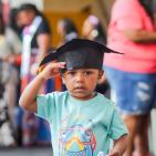 Young child wearing a graduation cap